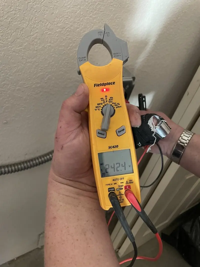Voltage testing with clamp meter during Recessed Lighting Installation in Dinuba